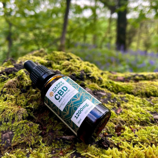 Happy Hemper 1200mg Cold Pressed CBD Oil in a forest