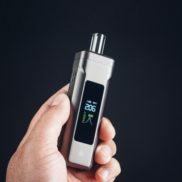 Person holding a Nebula Titan Dry Herb Vaporizer