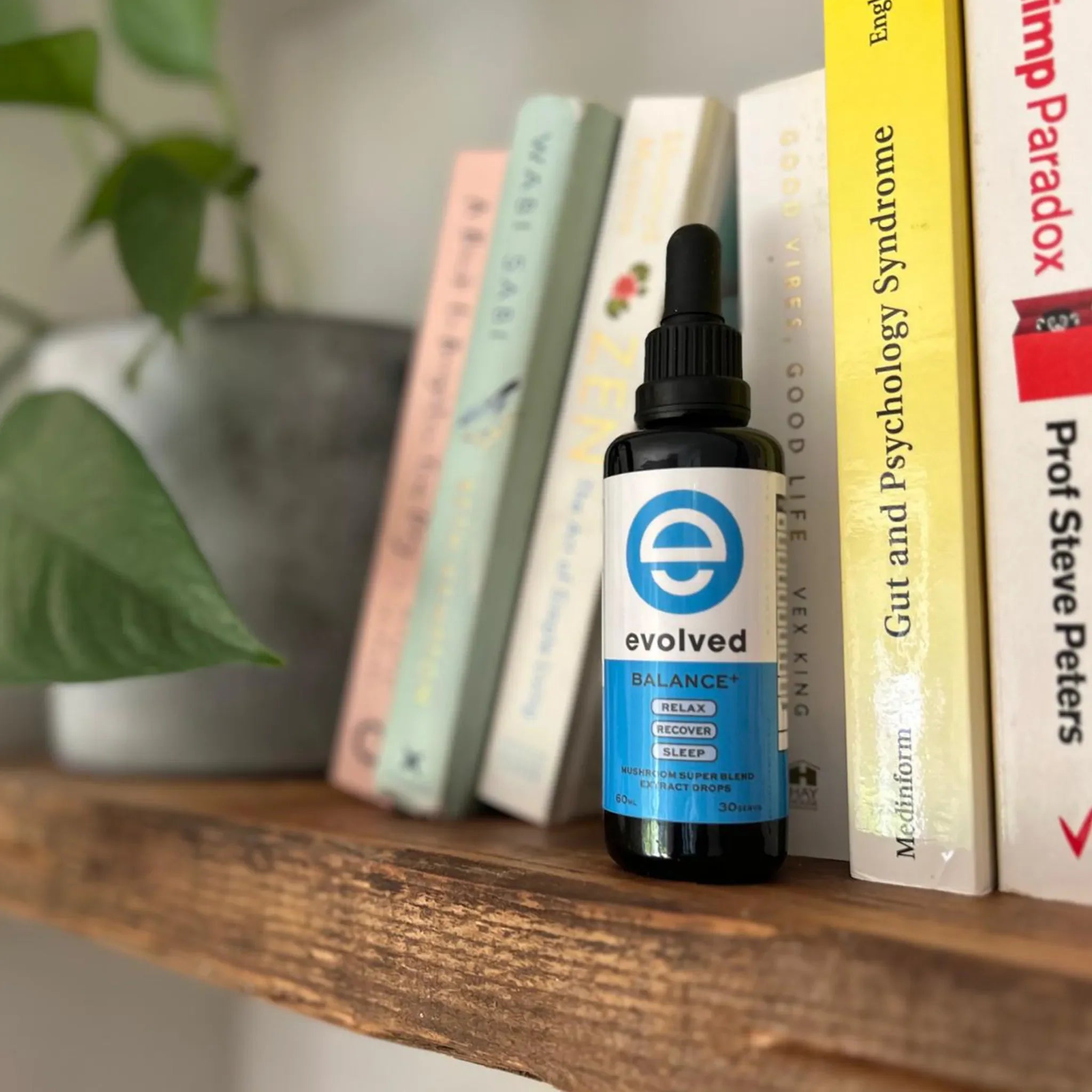 Evolved Tinnitus Calm Mushroom Extract on bookshelf