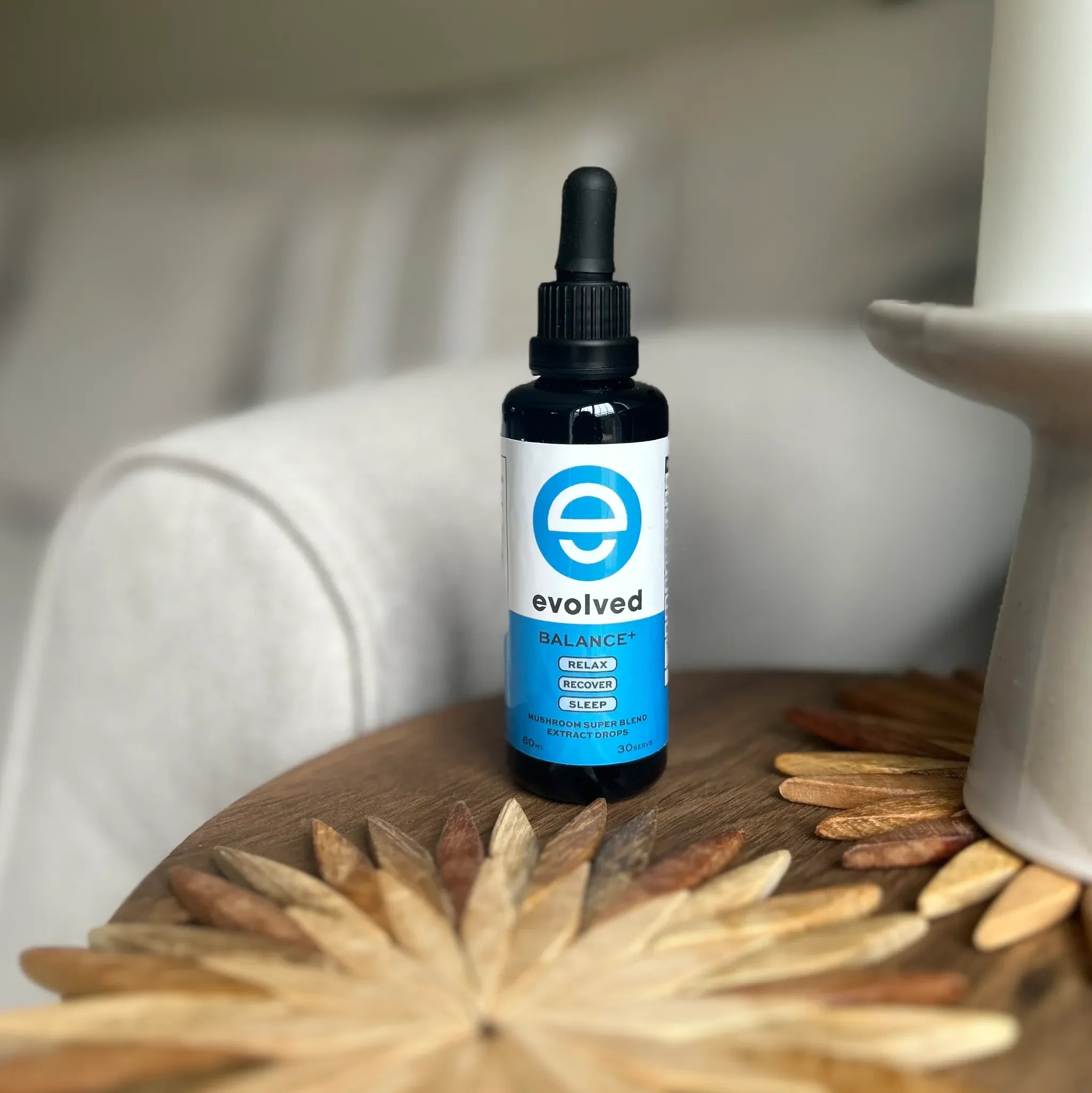 Evolved Tinnitus Calm Mushroom Extract on a wooden table